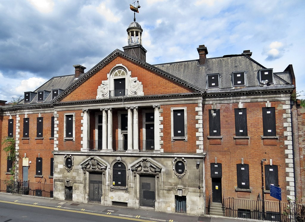 Haggerston Baths  topped with a weathervane in the form of a ship opened in 1904 featuring one pool in a large barrel vaulted hall, slipper baths and a laundry at a time when local houses did not have their own baths