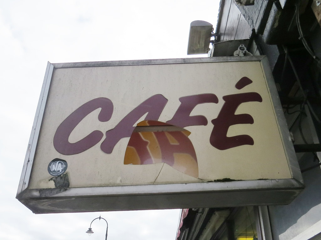 Cracked Café Sign on the side of a shop in Kentish Town, North London