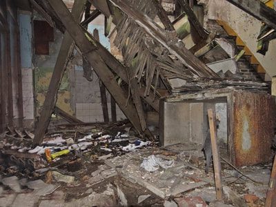 Collapsed roof. Interior of abandoned long derelict fishmongers in Limehouse