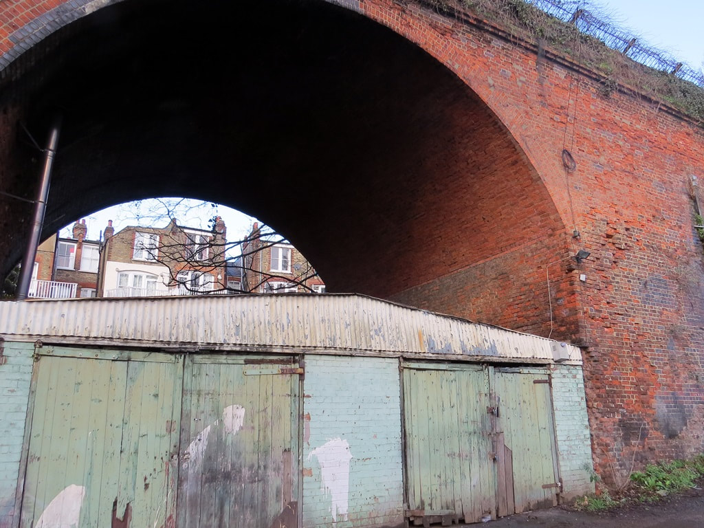 Neglected garages beneath the disused railway viaduct in Muswell Hill, North London