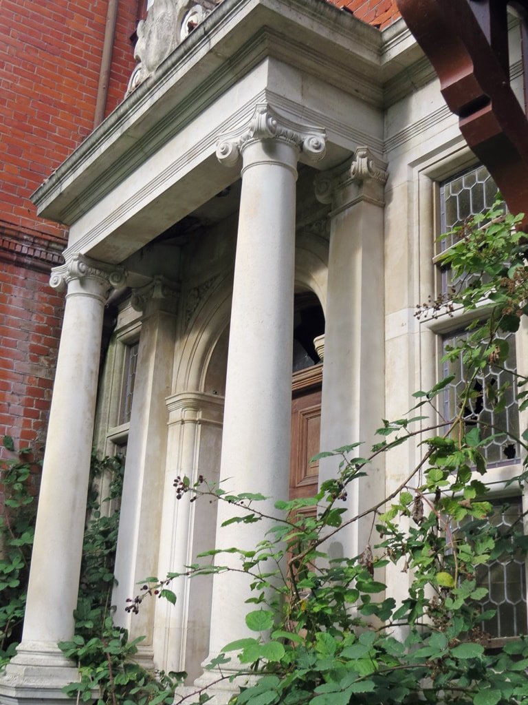 Overgrown portico of derelict London mansion