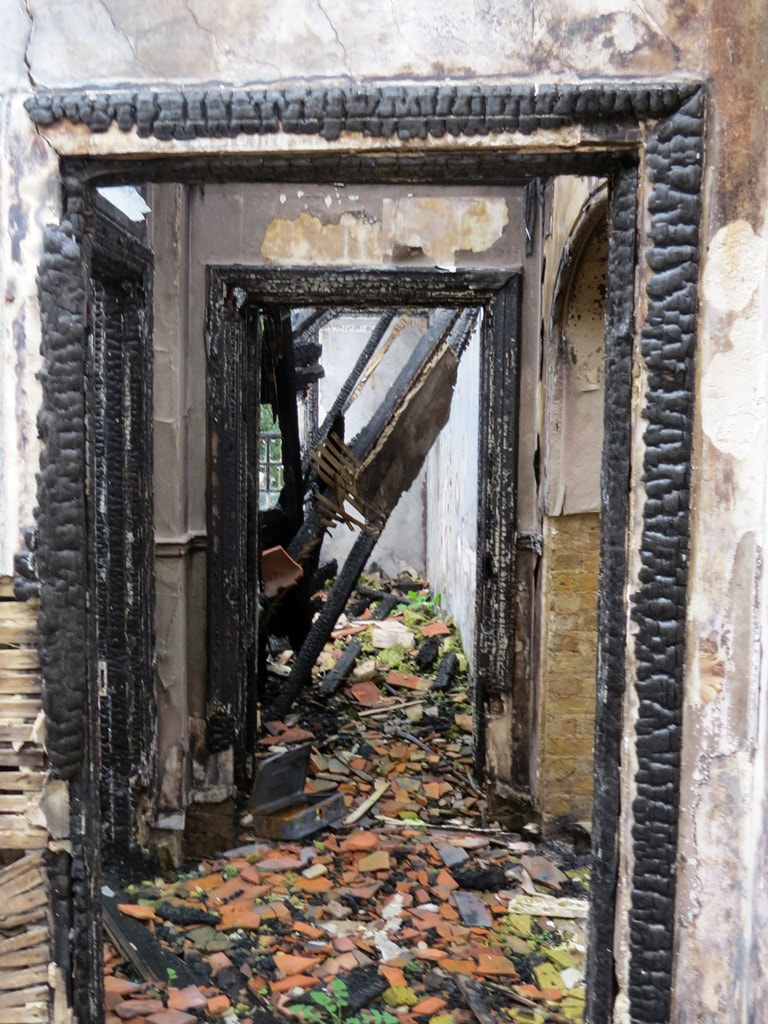 Burnt out corridors in fire damaged abandoned London mansion