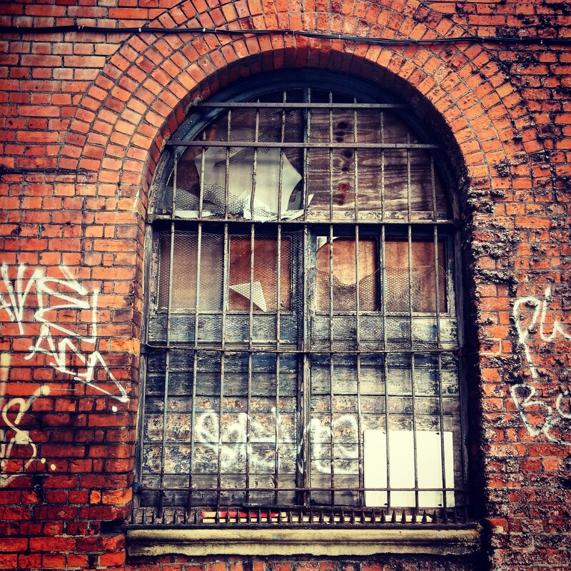 The decaying window of the former Shadwell and St George in the East Railway Station in East London that closed 1941