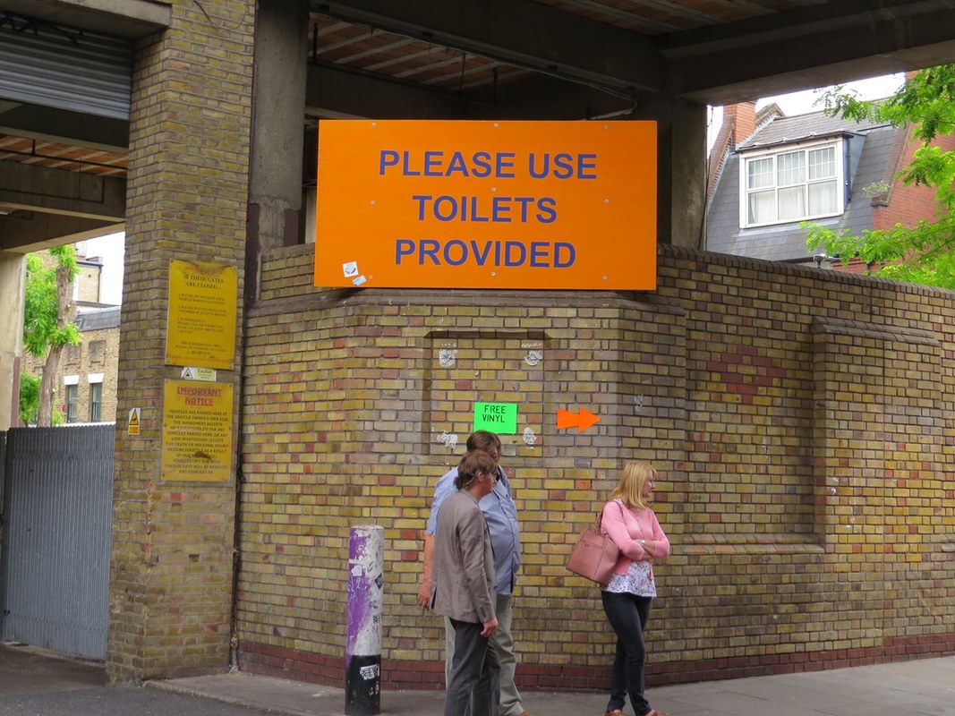 Please use toilets provided sign for public conveniences in Brick Lane, East London, E1