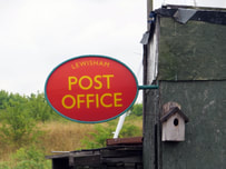 Picture of Lewisham Post Office sign at dilapidated building in boatyeard at Swancombe Marshes