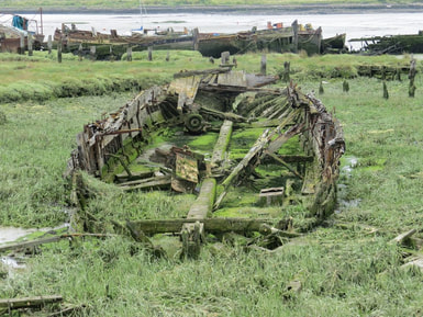 Picture of Derelict sailing barge originally used to transport locally dug clay to cement works.Many barges ended up as houseboats at the adjacent Hoo Marina though as their condition deteriorated they are hulked on the salt marsh and left to further decay. 