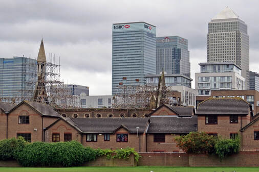 The shell of derelict Saint Saviour's Church in Poplar E14 London with Canary Wharf in the background