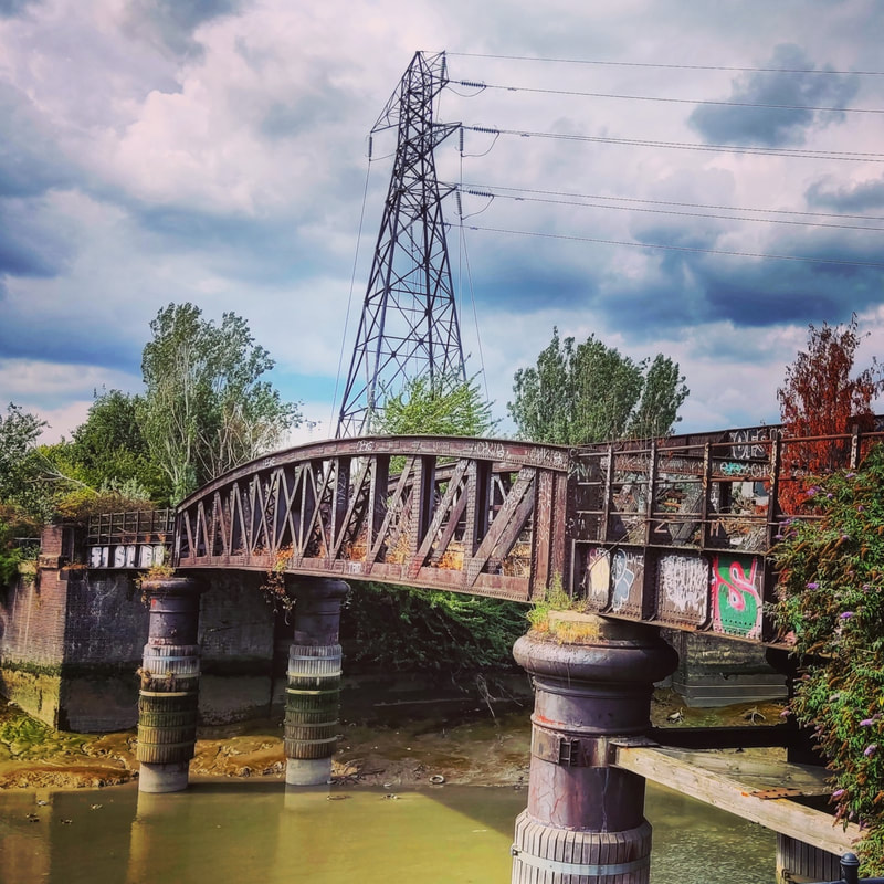 Picture of rusty derelict railway bridge with nature taking over across the Bow Creek
