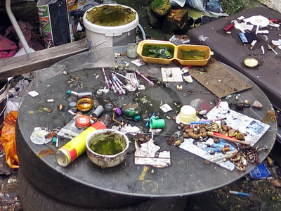 Needles for drugs. Coffee table in East End squat with syringes