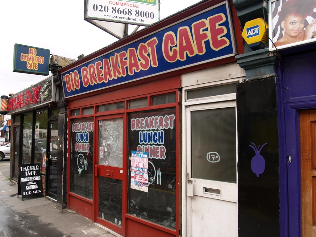 The derelict Big Breakfast Cafe, South Norwood, with window still advertising breakfast, lunch and dinner