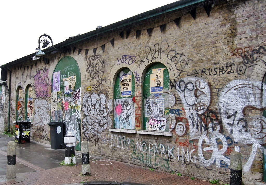 Graffiti covered disused Victorian Shoreditch London Underground station in East London