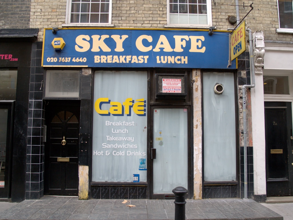 Whitewashed windows of shutdown Sky Cafe in Central London