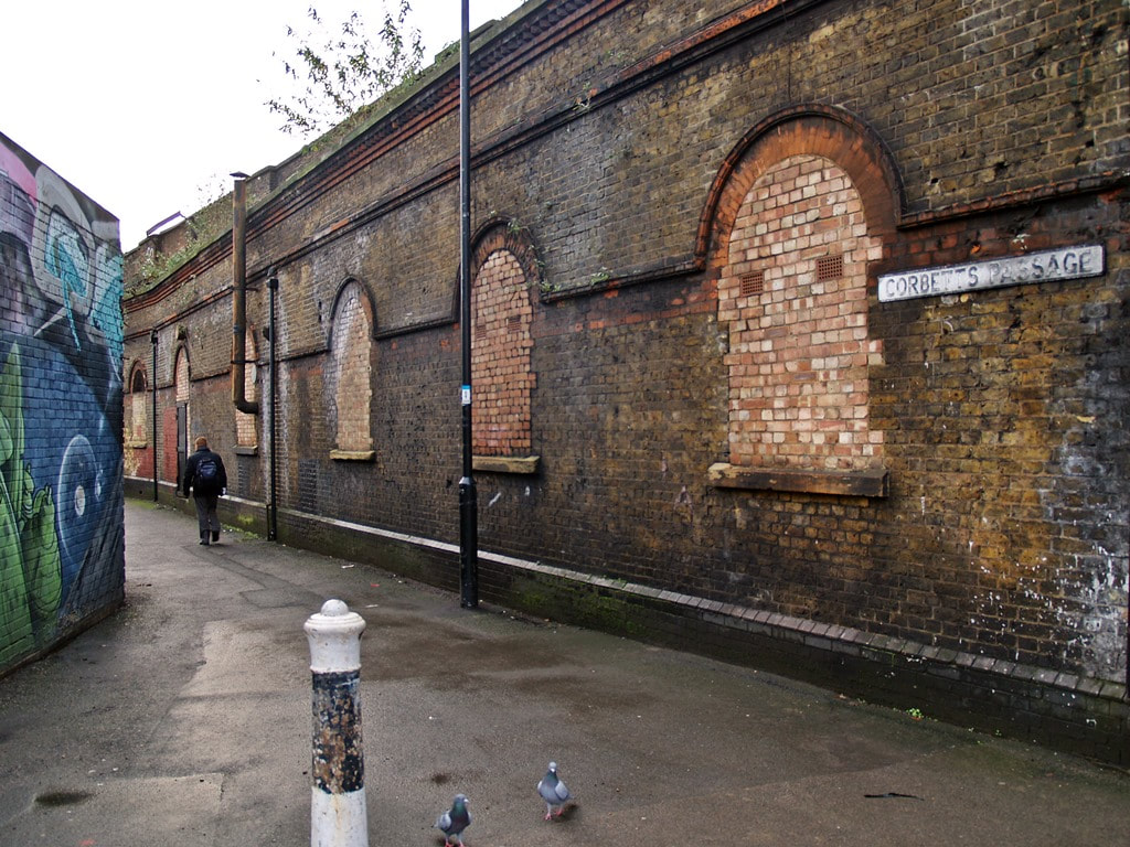 The abandoned interior of the ticket hall of Southwark Park Station is not visible due to bricked up windows