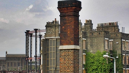 Industrial wasteland of chimneys, boarded up tenements and gas holders viewed from St Pancras station in London