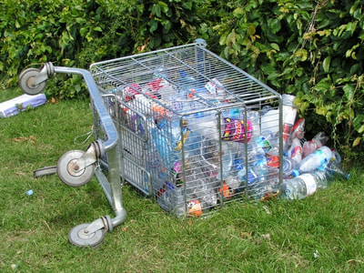 Abandoned shopping trolley full of rubbish in Stonebridge Park, North London
