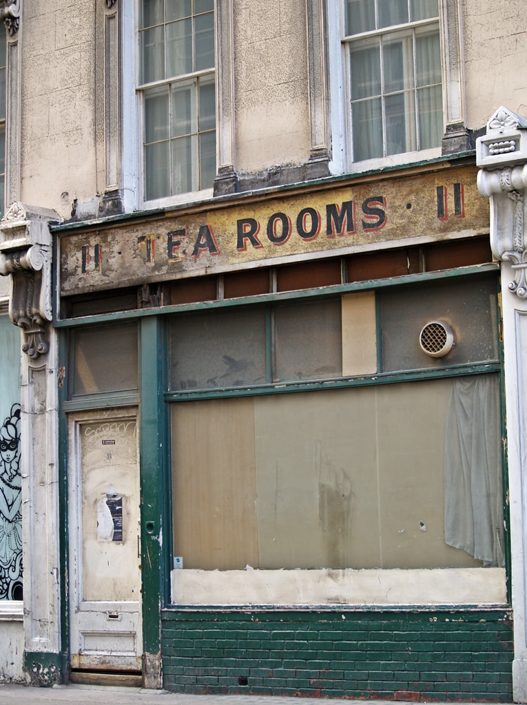  hand-painted ghost sign for The Tea Rooms on derelict cafe at 11 Museum Street in Bloomsbury, London