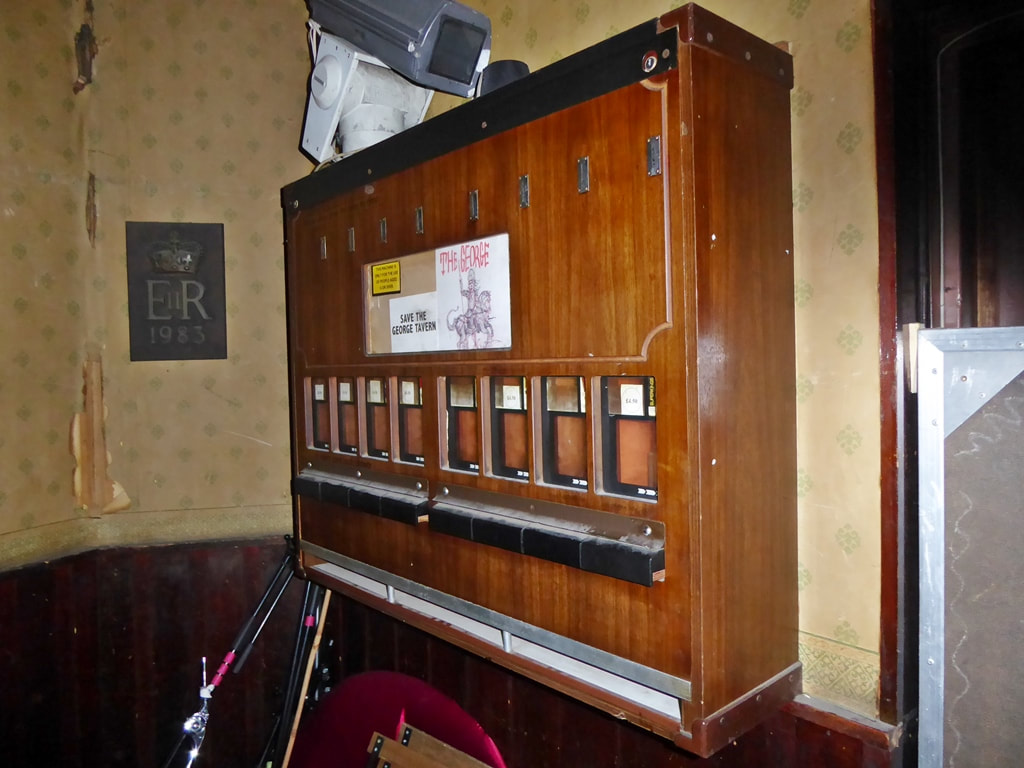 Wooden cigarette machine in the back of a pub in East London