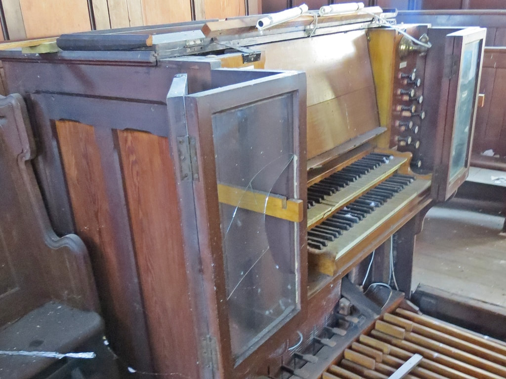 neglected church organ in derelict site in South London