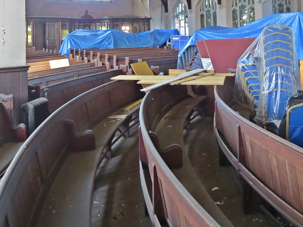 dilapidated pews in derelict church in Borough of Croydon