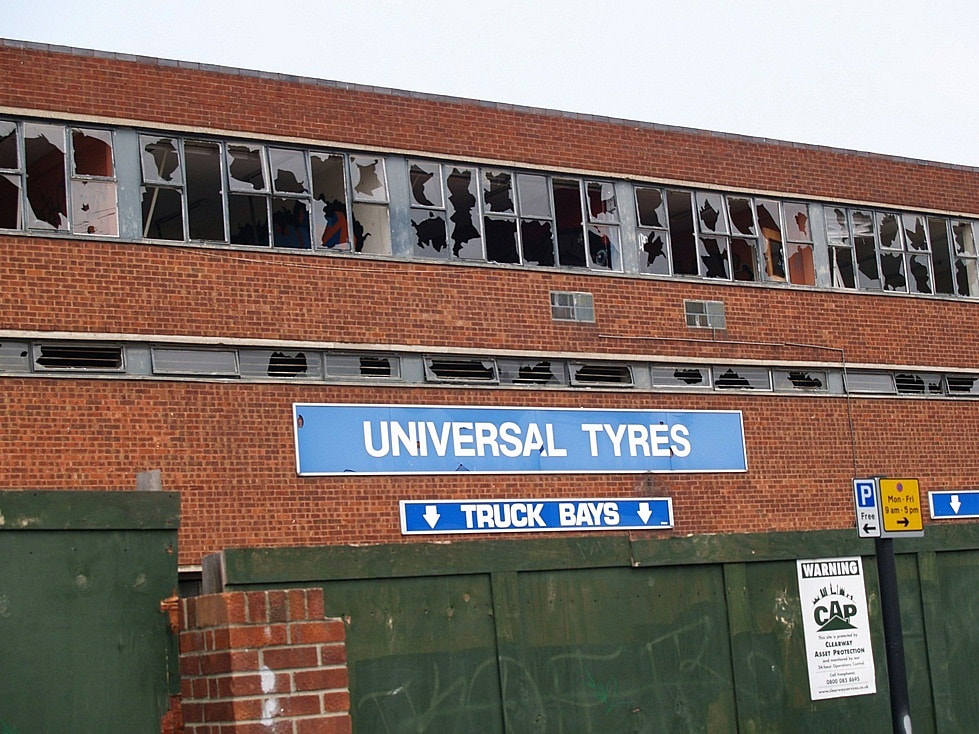 broken windows at derelict Universal Tyres in Deptford