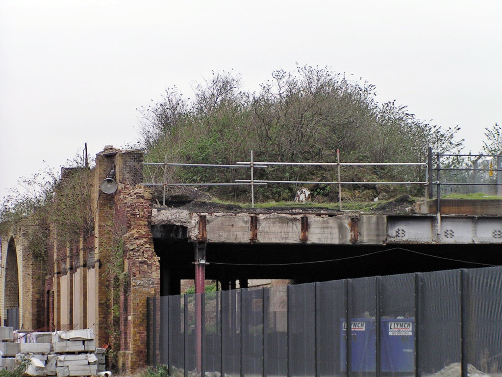 Overgrown remains of a partially demolished railway viaduct in  Bethnal Green, East London