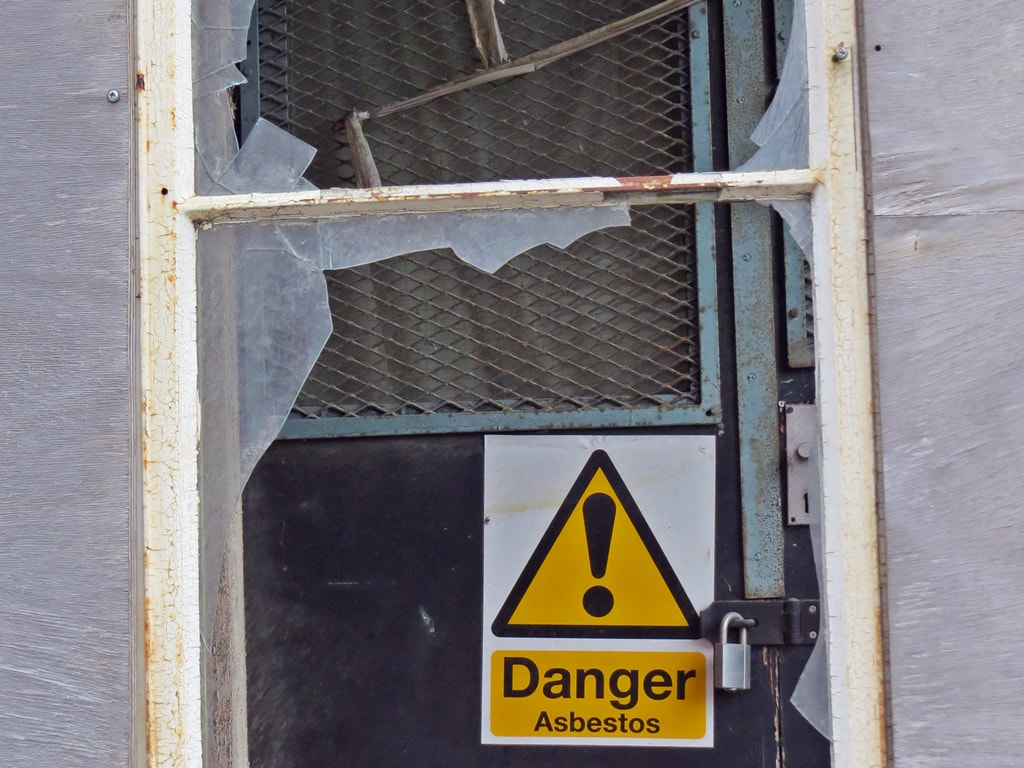 Broken window at deteriorating hospital in East London, UK