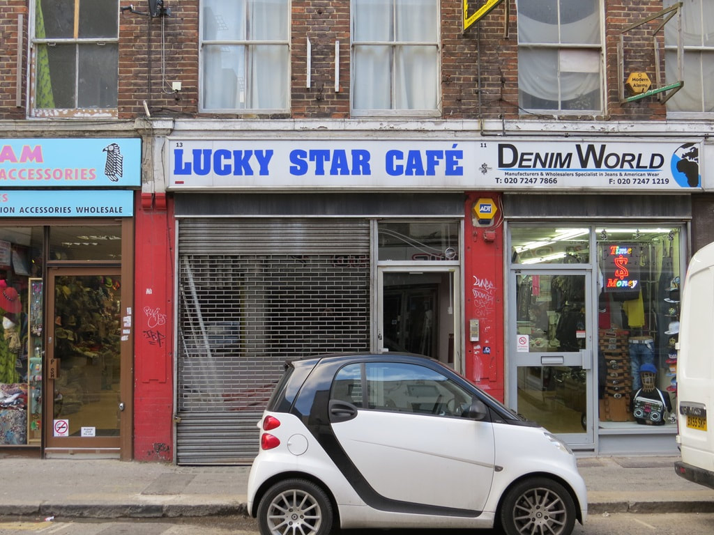 Smart Car parked outside the closed down Lucky Star geasy spoon Cafe, Whitechapel, E1
