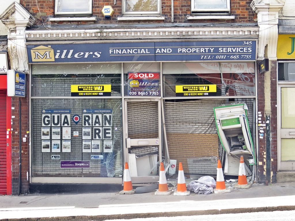 Picture of smashed shop frontage of defunct Millers Financial and Property Services Whitehorse Road Croydon